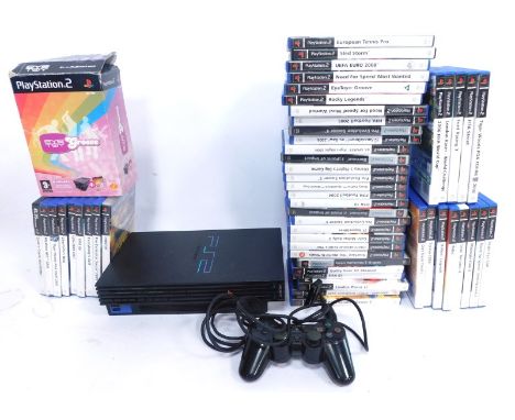A Playstation 2 console, games and accessories, including Eye Toy Groove, International Tennis Pro, Pro Evolution Soccer Six,