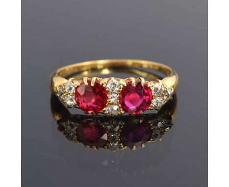 A late 19th/early 20th century ruby and diamond ring, the two rubies totalling approx. 0.9ct, size R, 2.9g 