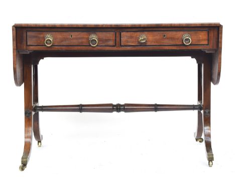 A Regency mahogany and ebony inlaid sofa table, two drawers and two opposing blind drawers, the end supports joined by centra