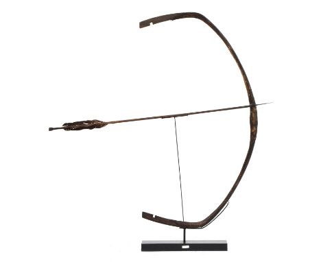 A Chinese Manchu style composite bow, 19th century, mounted with arrow, the bow 106cm long, currently stands 117cm highPLEASE