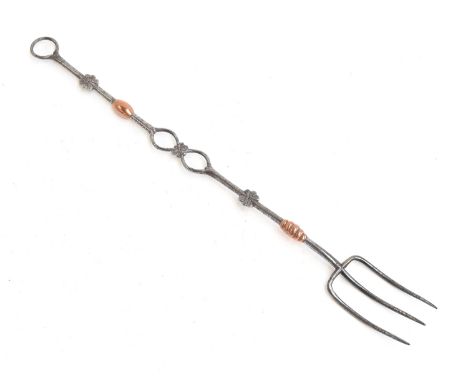 A Cotswold school steel and copper three pronged toasting fork, probably Ernest Gimson, made by Alfred Bucknell, 53.5cm long 