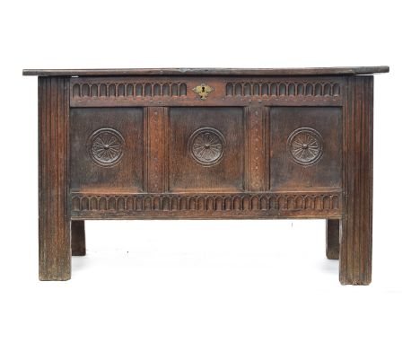 A late 17th/early 18th century oak three panel coffer, each panel carved with central apotropaic symbol, 124cm wide, 53cm dee