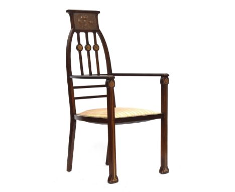 An unusual early 20th century Arts &amp; Crafts Liberty style open armchair, crested with a beaten copper panel, over three b