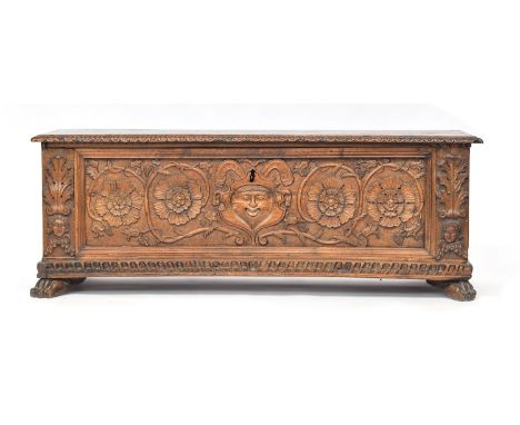 A 16th century and later Italian walnut cassone, the hinged lid with gadrooned edge, the front panel carved with central huma