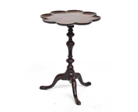 An 18th century mahogany wine table, the scallop edge dished top above a baluster turned column, on tripod cabriole legs, 48c