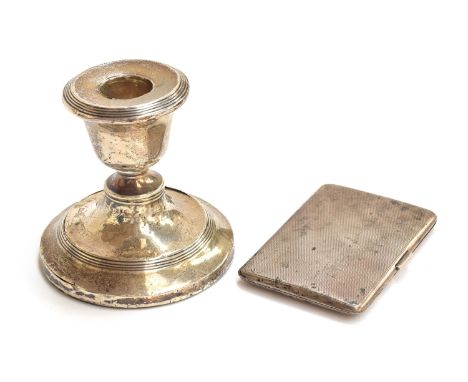 An Edwardian loaded silver dwarf candlestick, 8cm high; together with a George V engine turned cigarette case, Birmingham 192