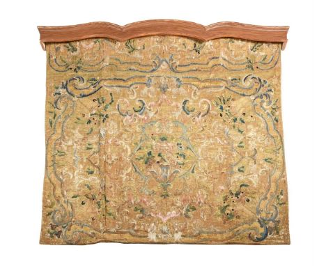 An 18th century tapestry hanging, probably Italian or Spanish, woven predominately in wool with scrolling floral arabesques i
