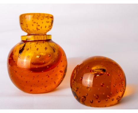 A Whitefriars glass controlled bubble inkwell, in amber, the stopper with etched number 22 to underside, designed by William 