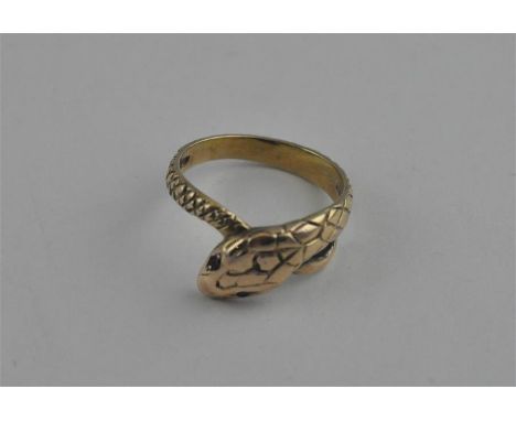 A 9ct. gold snake ring, having simulated scale decoration with red gem set eyes. (5g)