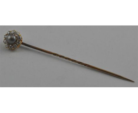 A Garrard &amp; Co. retailed yellow metal, pearl and diamond tie pin, having central natural pearl surrounded nine brilliant 