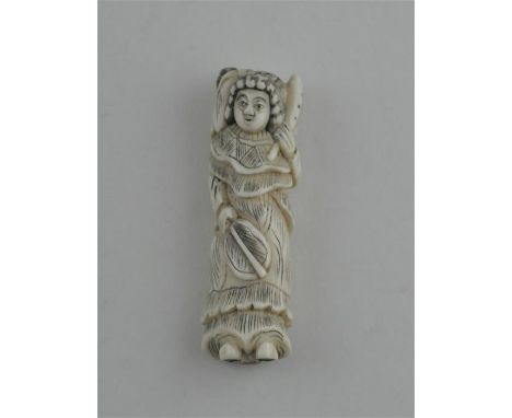 A Japanese late Meiji period carved ivory netsuke, of a standing female woman with fan carrying a smakk figure upon her shoul