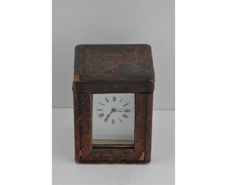 A French brass carriage clock, having white enamel Roman numeral dial, in original leather case with key and&nbsp;in good wor