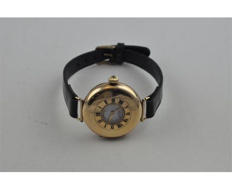 A 9ct. gold half hunter style wristwatch, manual movement, having white enamel Roman numeral dial with subsidiary seconds dia