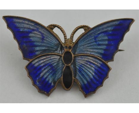 An enamel butterfly brooch in shades of blue. 4cms wide.