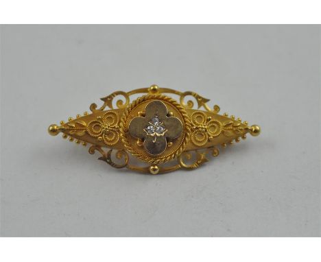 A&nbsp;15ct. gold and diamond set brooch,&nbsp;late 19th century,&nbsp;of pointed oval form, having openwork scroll and bead 