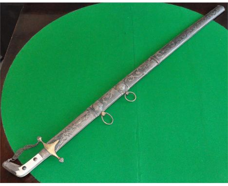 An Islamic interest silver mounted sword, probably late 19th century, having brass hilt with chain guard, engraved silver mou