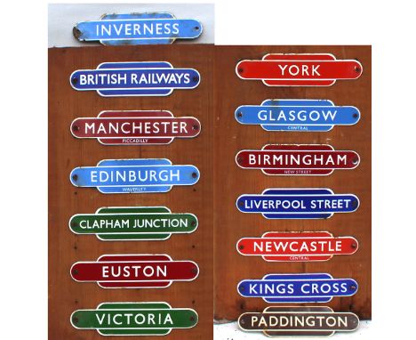 Garnier Miniature Enamel Totems qty 14, 12 of which are mounted on a wooden board, comprising: British Railways; Manchester P