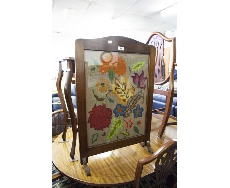 A MAHOGANY EDWARDIAN SERPENTINE TOP SIDE TABLE, ON CABRIOLE SUPPORTS AND AN OAK FRAMED FIRE-SCREEN WITH NEEDLEWORK FEATURE (2