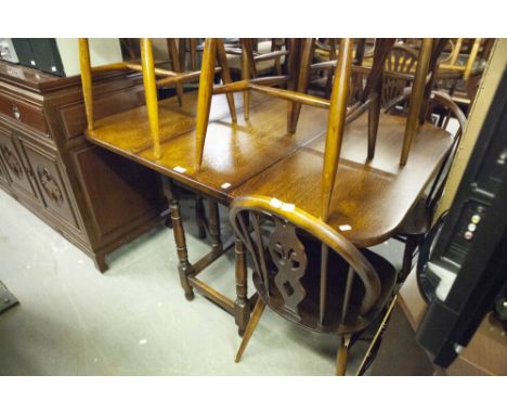 AN ELM AND OAK OBLONG GATE LEG DINING TABLE, ON BALUSTER SUPPORTS 