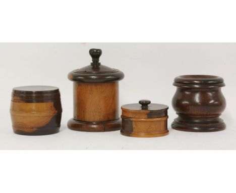 Two lignum vitae treen tobacco box and covers, of cylindrical form, a lignum vitae string box with cutting finial, and a burr