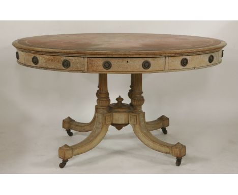 A Victorian light oak oval centre table, with leathered top and four drawers, on a base with four columns and splay legs, 136