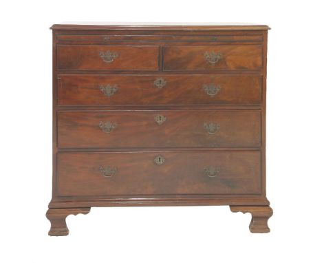 A George III mahogany bachelor's chest, fitted with brushing slide, over two short and three long drawers, upon ogee bracket 