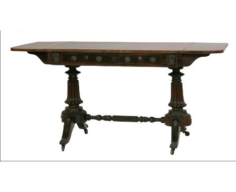 A rosewood and mahogany sofa table, the crossbanded top over two drawers, turned supports on shaped legs, with gilt mounts an