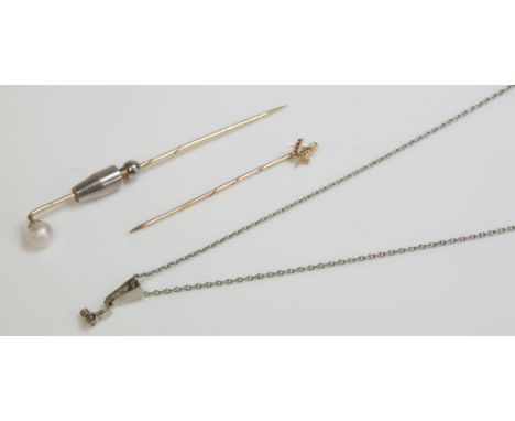 A gold stick pin, mounted with a pearl, pearl untested, another gold Masonic stick pin, and a white gold diamond set bale on 