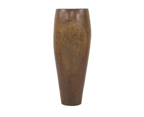 An African or Indonesian carved vessel or drum, hewn from a single trunk, with base plate, 96cm