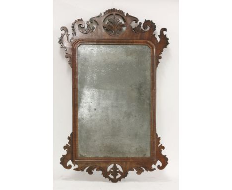 A 'Chippendale' walnut fret framed wall mirror, with carved incised decoration, 78 x 34cm