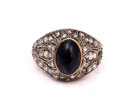A ROSE DIAMOND AND CABOCHON BLUE GEM SET RINGCollet set to the centre with an oval cabochon blue gemstone, otherwise mounted 