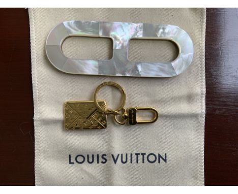 A LOUIS VUITTON GILT METAL KEY CHAIN (2)And a Hermes 'Chaine d'Ancre' scarf ring, wood with mother of pearl finishCondition r