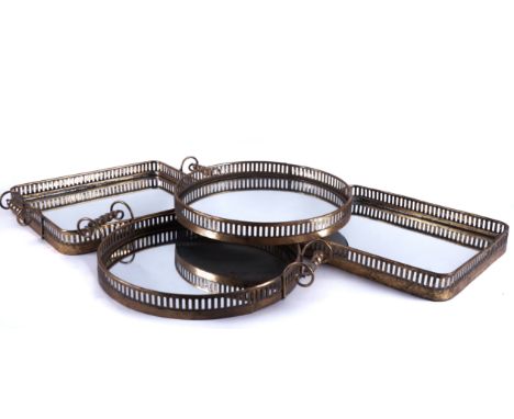 FOUR GILT-METAL MOUNTED MIRROR GLASS SERVING TRAYS (4)Recent ManufactureWith pierced galleries, a circular and a rectangular 