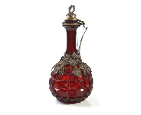 A VICTORIAN SILVER-GILT MOUNTED FACETED RED GLASS CLARET JUGThe faceted red glass body with an applied mount designed as frui