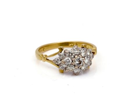 AN 18CT GOLD AND DIAMOND CLUSTER RINGClaw set with circular cut diamonds, with the principal diamond mounted at the centre, b