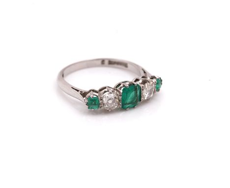 A PLATINUM, EMERALD AND DIAMOND FIVE STONE RINGClaw set with three cut cornered square step cut emeralds alternating with two