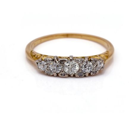 A GOLD AND DIAMOND FIVE STONE RINGMounted with a row of graduated cushion shaped diamonds and with four pairs of diamond poin