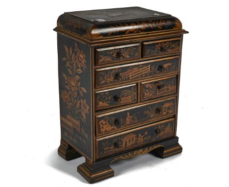 A CHINOISERIE DECORATED CADDY TOP MINIATURE CHESTWith an arrangement of four short and three long drawers 32cm wide; 43cm hig