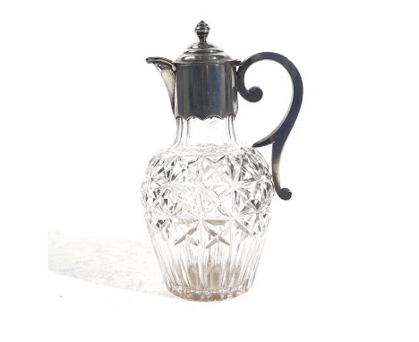 A VICTORIAN SILVER MOUNTED FACETED GLASS CLARET JUGWith a scrolled handle and turned finial to the hinged lid, height 22cm, L