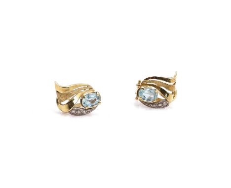 A PAIR OF GOLD, AQUAMARINE AND DIAMOND EARCLIPSEach in a scroll design, claw set with an oval cut aquamarine and with three c
