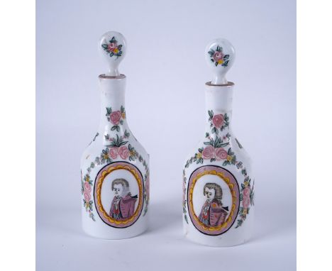 A PAIR OF BOHEMIAN MILCHGLAS DECANTERS AND STOPPERS (4)Each enamelled with an oval portrait medallion against a ground scatte