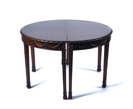 A PAIR OF GEORGE III MAHOGANY SEMI-ELLIPTICAL CONSOLE TABLES (2)With swag carved frieze on tapering square supports, 122cm wi
