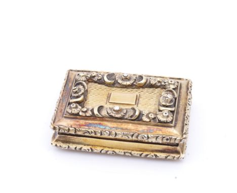 A WILLIAM IV SILVER GILT VINAIGRETTEOf rectangular form, with a floral and foliate scroll engraved grille, the exterior with 