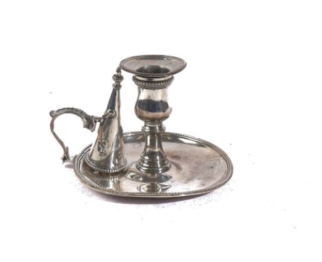 A GEORGE III SILVER CHAMBER STICK WITH A SNUFFING CONEOf circular dish form, with a beaded rim, crest engraved, diameter 11.3