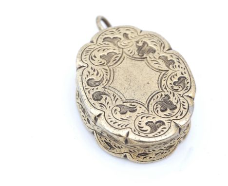 A VICTORIAN SILVER GILT VINAIGRETTEOf shaped oval form, with a floral and scroll engraved grille, the exterior with stylized 