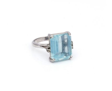 AN AQUAMARINE AND DIAMOND RINGClaw set with a cut cornered rectangular step cut aquamarine, between circular cut diamond set 