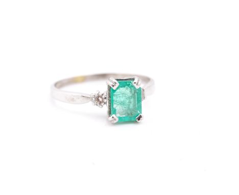 AN 18CT WHITE GOLD, EMERALD AND DIAMOND RINGThe rectangular step cut, cut cornered emerald, claw set with circular cut diamon