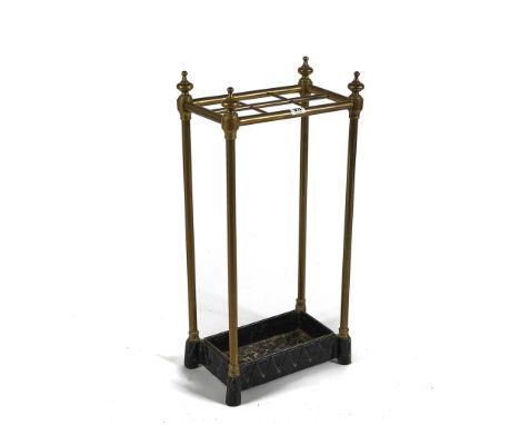 A VICTORIAN BRASS SIX DIVISION STICK STANDWith cast iron drip tray, 31cm wide; 63cm high