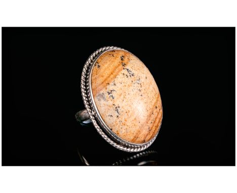 Picture Jasper Ring, a 35ct oval cut cabochon of natural picture jasper, bezel set in silver with a beaded border; size Q