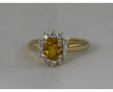 18ct Gold Set Diamond and Orange Sapphire Cluster Ring - Flower head Design. The Central Orange Sapphire Surrounded by 16 Sma